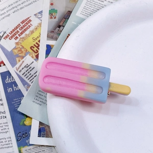 Detail of pink and blue gradient popsicle hair clip on a white ceramic plate
