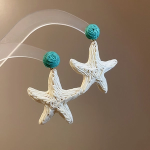 Handmade woven starfish drop earrings in cream and teal blue for a beach summer look