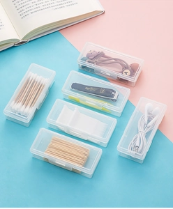 Macro view of compact clear plastic storage box for cotton swabs and hair accessories