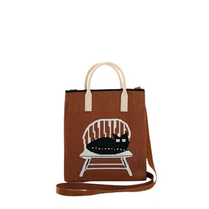 Knitted tote bag with black cat pattern, brown contrast finish and shoulder strap