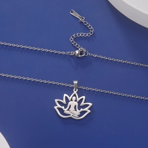 Macro shot of silver stainless steel lotus yoga pendant with S-STEEL hallmark detail