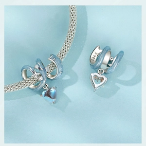 Detailed macro view of S925 sterling silver heart charm with blue enamel and zircon