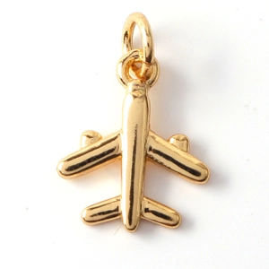 Macro shot of a polished golden airplane charm pendant for DIY jewelry making