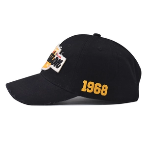 Detail of vintage black cotton baseball cap with 1968 embroidery and distressed brim effect