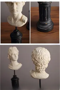 Detailed close-up of David bust sculpture with antique finish on a black pedestal