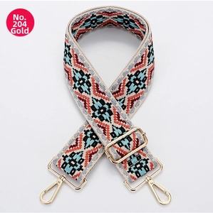 Detail of adjustable geometric ethnic canvas bag strap with gold metal hooks and hardware