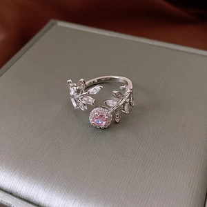 Macro shot of silver-plated open ring with pink zircon gemstone and leaf design