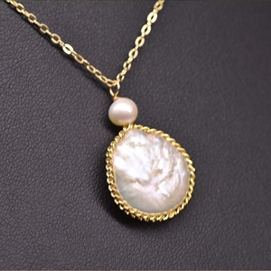 Macro detail of natural freshwater and baroque pearls wrapped in golden metal wire on leather