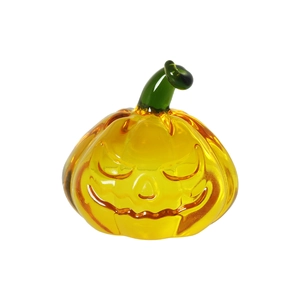 Transparent yellow crystal pumpkin figurine with Jack-o'-lantern face and green stem