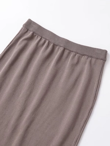Detail of the elastic waistband on soft stretch knit straight-cut skirt in brown
