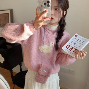 Pink plush crossbody phone bag styled with a knitted sweater and white lace skirt