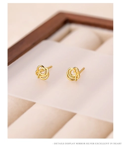 Detailed macro view of gold-plated cutout rose earrings crafted in high-quality silver