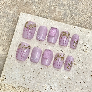 Handmade purple cat-eye press-on nails with 3D floral designs and square crystals