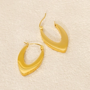 Minimalist 18k gold plated stainless steel U-shape hoop earrings on textured fabric