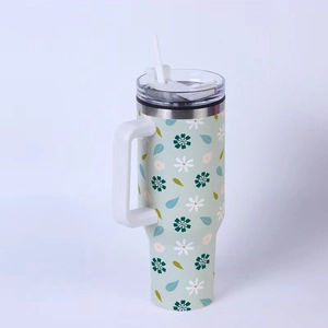 Close-up of mint green 40oz floral tumbler featuring white and dark green flower patterns