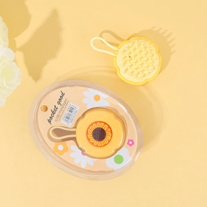 Detail view of yellow sunflower scalp massager with lanyard and packaging information