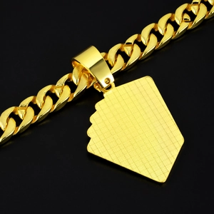 Close-up of gold Cuban chain and spade pendant with detailed metallic texture finish