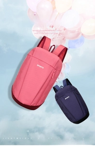 Detail view of pink and navy lightweight outdoor backpacks with hidden front zippers