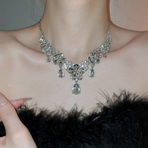 Detailed close-up of a silver flower necklace with marquise crystals and teardrop pendants