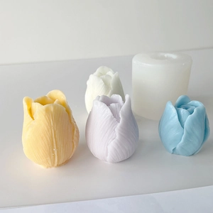 Detailed view of colorful tulip-shaped candles alongside a flexible silicone mold