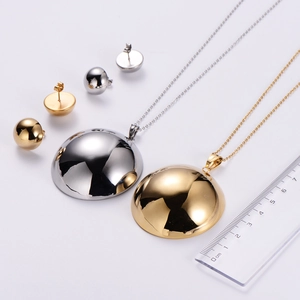 Macro view of minimalist semicircular pendant necklaces and earrings with measurement scale
