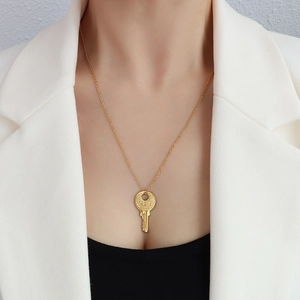 French style 18k gold key pendant necklace featuring detailed 121 engraving on a fine chain