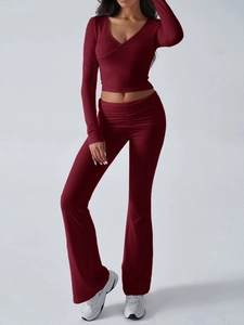 Detail of burgundy two-piece knit set featuring V-neck crop top and flared trousers