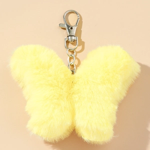 Close-up of bright yellow butterfly plush keychain with soft fur and silver metal lobster clasp