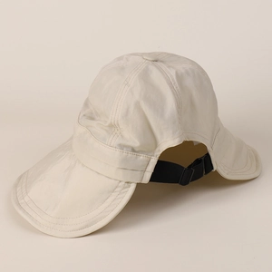 Detail of adjustable elastic drawstring and buckle on wide brim beige nylon sun hat