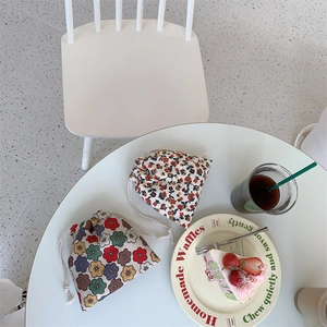 Detailed view of floral drawstring pouches in a cozy afternoon tea setting