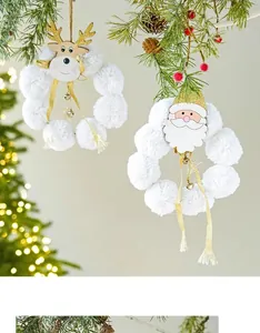Detail of Christmas wreath with plush reindeer and wooden portrait on pine branch