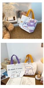 Cute canvas tote bag with bunny prints, purple handles, and plush teddy bear charm