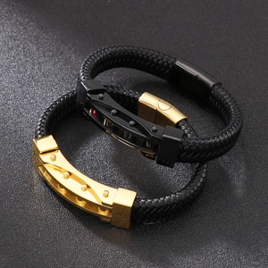 Detail of men's braided leather bracelets with gold and black industrial metal clasps