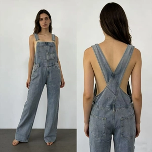 Detail showing back X-shaped straps and blue-gray washed denim texture of the overalls