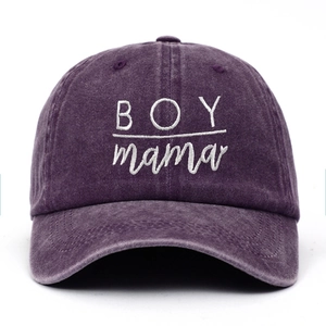 Detailed close-up of purple washed cotton baseball cap with white BOY mama embroidery