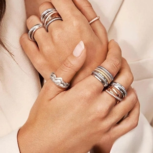 Detail shot of micro-pave crystal stacking rings in silver, gold, and rose gold finish