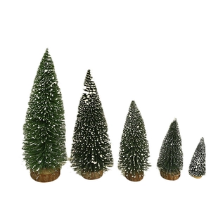 Five assorted mini frosted Christmas trees with wooden bases in graduated sizes on white