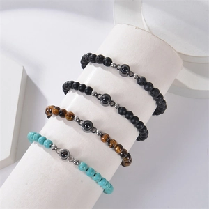 Detailed view of projection beads on natural tiger eye and turquoise beaded bracelets