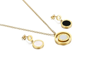 Detail of gold plated stainless steel jewelry set with Roman numerals and mother of pearl