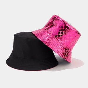 Detail shot of black and hot pink bucket hats with metallic fish scale texture finish
