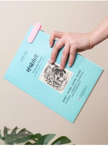 Pink soft silicone automatic page-following bookmark clipped on a book for easy reading