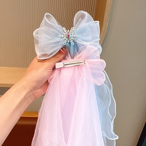 Pink and blue gradient bow hair clip with snowflake charms and long mesh ribbons