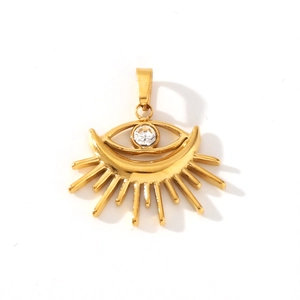 Macro view of gold stainless steel evil eye pendant with crystal and radiant rays