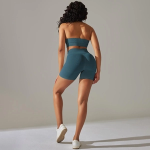 Close-up of seamless ribbed teal yoga set featuring high waist shorts and back view details