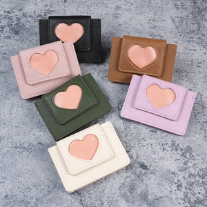 Minimalist heart-shaped cutout card holders in six macaron colors on stone texture