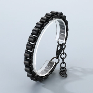 Vue détaillée du bracelet gourmette noir en acier inoxydable poli sur support acrylique