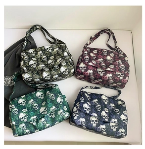 Detailed flat lay of four colorful nylon skull and rose patterned crossbody bags on white