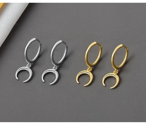 Detailed macro view of S925 engraved stamp on gold and silver crescent moon earrings