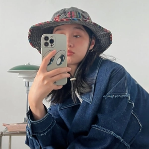 Grey sun bucket hat with ethnic woven band and dark blue frayed denim jacket outfit