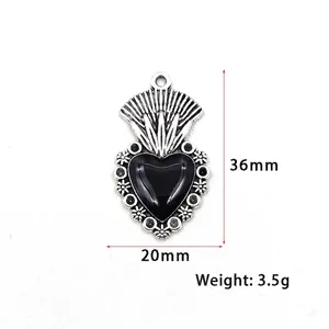 Vintage gothic black heart pendant with floral silver trim and dimensions 36x20mm